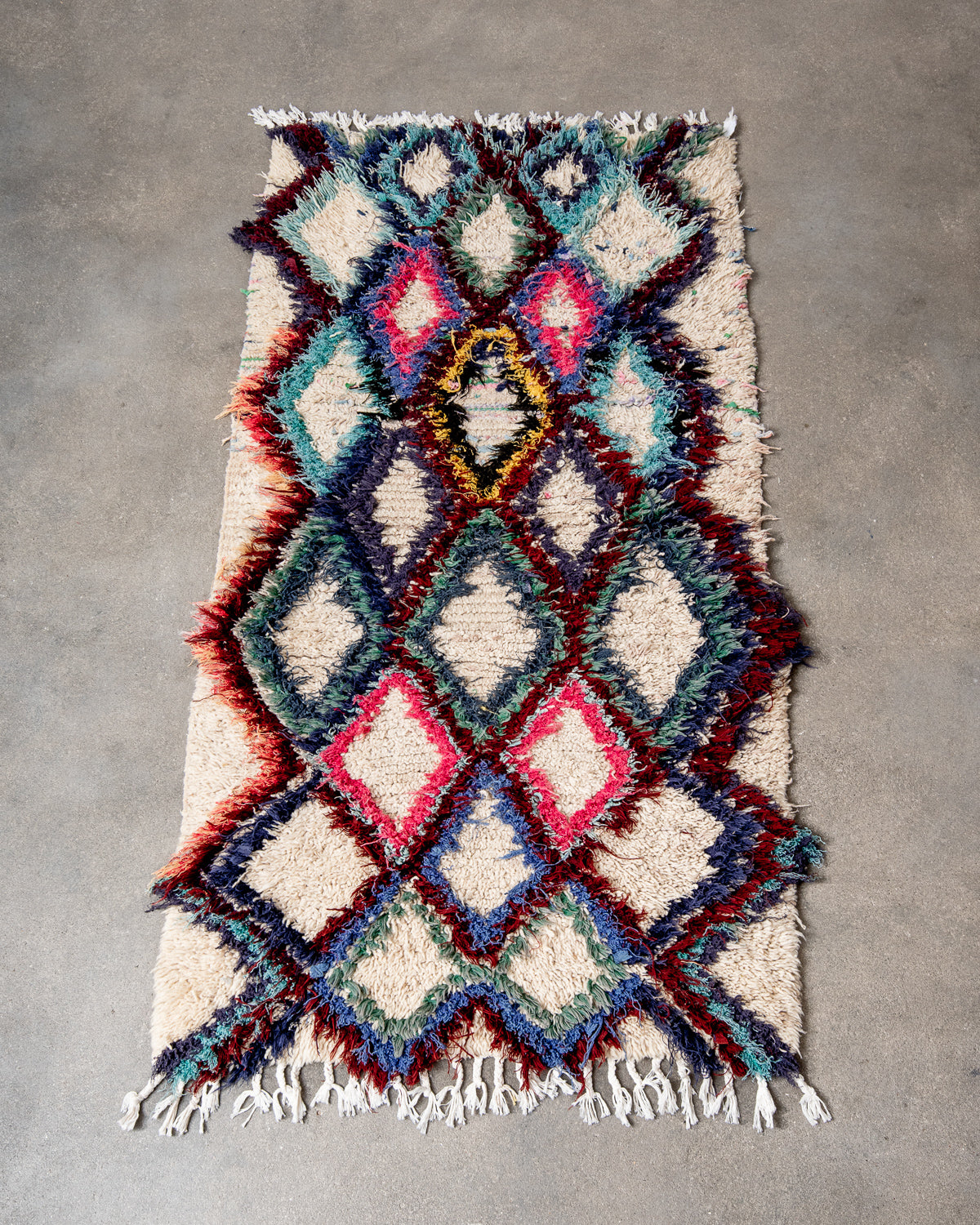 Modern designer vintage handcrafted Berber rug from Morocco. Boucherouite runner rug with beautiful colors and patterns.